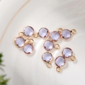 Macro view of 6mm lavender crystal birthstone pendants with gold faceted metal frames - 6mm / Gold - Purple (June)