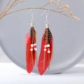 Bohemian long feather earrings featuring red beads and natural spotted textures - Red