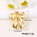 Detail showing dimensions of the gold bow pendant: 2.6cm height and 2.2cm width - Metallic Bow (A0226)