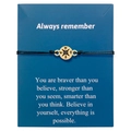 Detailed macro view of woven compass bracelet with gold pendant on blue display card - Gold Compass Braided Bracelet Blue Card (B2948-Bracelet)
