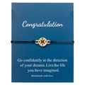 Macro shot of black woven compass bracelet on navy blue greeting card packaging - Gold Compass Bracelet with Card (B2951-Bracelet)