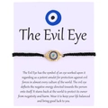Handwoven black evil eye bracelet with gold metal pendant and blue zircon inlay on a card - Textured Round Eye (B0018)