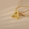 Macro view of gold 3D bubble letter A pendant on a sleek snake chain necklace - Letter A Style (24WN028)