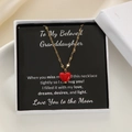 Detail of red heart pendant necklace on a message card inside a white jewelry gift box - Granddaughter Theme
