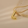 Detailed view of a golden 3D bubble letter L pendant on a fine snake chain necklace - Letter L Style (24WN028)