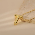 Macro detail of golden 3D bubble letter T pendant on a sleek snake chain necklace - Letter T Style (24WN028)