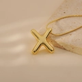 Macro shot of 18k gold plated bubble letter X pendant on smooth snake chain necklace - Letter X Style (24WN028)
