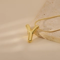 Detail shot of golden letter Y pendant with polished finish on a sleek snake chain - Letter Y Style (24WN028)