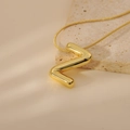 Detailed close-up of bubble-style gold letter Z pendant on a sleek snake chain necklace - Letter Z Style (24WN028)