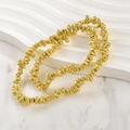 Double strand of irregular gold-plated lava stone beads displayed on a white stand - Lava Gravel (Approx 4-7mm) / Gold