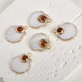 Close-up of five fan-shaped shell pendants with gold plating and red carnelian stones - Red Agate Shell (A1-283)