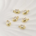Macro shot of 14k gold-plated oval zircon charms for DIY jewelry making on white tray - Oval Style / 11.6*7mm / 14K Gold