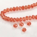 Detalle macro de cuentas facetadas naranjas con destellos dorados para joyería DIY - Aproximadamente 8 * 6 mm / Rojo