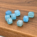 Macro shot of light blue translucent cube-shaped glass beads for DIY jewelry making - Blue Stone Cube