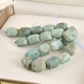 Macro detail of irregular faceted Amazonite beads in natural blue-green tones on string - Amazonite / 1 Piece