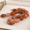 Faceted natural red agate stones showing unique textures and high glass luster - Southern Red Agate / 1 Piece