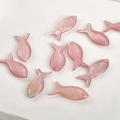 Macro view of pink iridescent fish-shaped pendants for DIY jewelry making and crafting - Pink Purple Fish
