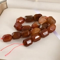 Macro detail of faceted red agate barrel beads with natural texture in jewelry box - Red Agate / 1 Piece