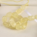 Macro shot of faceted light yellow natural crystal beads on a delicate string - Citrine / 1 Piece