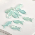 Macro view of 10 iridescent fish-shaped shell pendants with pre-drilled holes for DIY jewelry - Blue Fish