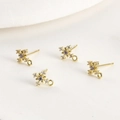 Detailed close-up of 14k gold plated snowflake earrings with purple zircon and small crystals - 14k Gold Plated Purple Zircon Cross