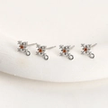 Macro detail of silver snowflake charms with orange zircon center for DIY jewelry making - White K Plated Red Zircon Cross