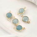 Detail of light blue faceted crystal charms with gold-plated double rings for DIY jewelry - Amazonite