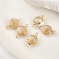 Detail of round gold-plated natural stone pendants with double loops for DIY jewelry making - Rutilated Quartz Gold