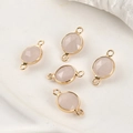 Detailed view of five pink crystal pendants with gold plated edges for DIY jewelry making - Rose Quartz