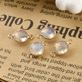 Close-up of four faceted round opal charms with double gold loops for jewelry making - Opal