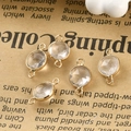 Macro shot of faceted crystal charms with gold-plated edges and double jump rings - White Crystal