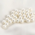Macro shot of loose white imitation pearls with pre-drilled holes for DIY jewelry making - 6mm White Pearl Bead (Approx 6.2mm)
