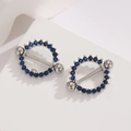 Silver stainless steel nipple shields with circular blue zircon stones on stone base - Silver Blue