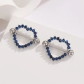 Macro shot of 18K gold plated heart nipple ring set with sparkling deep blue zircons - Silver Blue