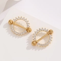 Close-up of 18K gold-plated nipple rings with radiating zircon stones on stone stand - Gold White