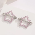 Detail view of pentagram nipple shield with pink zircon stones on steel barbell jewelry - Silver Pink