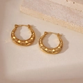 Macro view of 18K gold plated hoop earrings with embossed cross and diamond textures - Hammered Crescent Style (B)