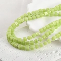 Detailed macro view of light green sugar-shaped glass beads for DIY jewelry making - One Strand Approx 55 Beads / Green Jade