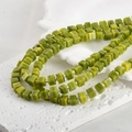 Detailed close-up view of 6mm green cube glass beads with natural jade-like texture - One Strand Approx 55 Beads / Olive Jade Color