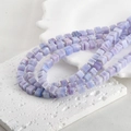 Macro view of lavender cube glass beads with silver spacer accents on white stone - One Strand Approx 55 Beads / Purple Agate