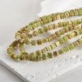 Macro detail of cube striped glass beads in green and brown for DIY jewelry making - One Strand Approx 55 Beads / Floral Green