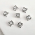 Macro shot of silver flower spacer beads with zircon settings for DIY jewelry making - Clover Spacer Bead (Silver)
