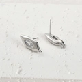 Macro-opname van S925 zilveren marquise zirkoon oorknopjes op witte stenen textuur basis - Zilverkleur Marquise Zirconia Oorknopje (1 Stuk)