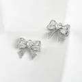 Close-up of bow knot charms with sparkling zircon stones for DIY jewelry making - Zirconia Bow Style / Silver