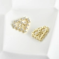 Detail view of 14k gold plated heart charm with bow design and shimmering zircon stones - Heart Bow Style / Gold