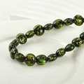Macro shot of dark green glass beads with gold foil flakes on a white ceramic tray - 6# Yellow Green Foil Flat Round