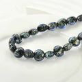 Macro shot of flat round glass beads with colorful foil inserts for DIY jewelry making - 8# Blue Foil Flat Round