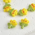 Macro detail of yellow glass tulip beads with red dots and green leaf for DIY jewelry - 1 Piece / Yellow
