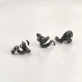 Detail of matte black snake-shaped spacers with realistic scale texture for DIY jewelry - Black