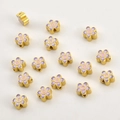Macro detail of colorful enamel flower beads with gold base for DIY jewelry making - Gold Purple Pink Flower